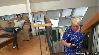 Young sponger fucks busty tow-headed granny from behind
